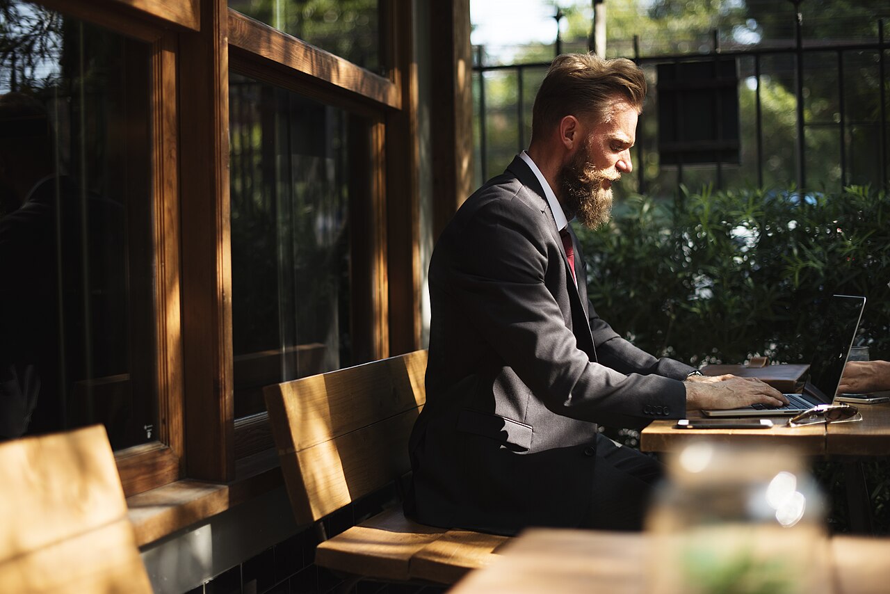 Someone working on a laptop outdoors