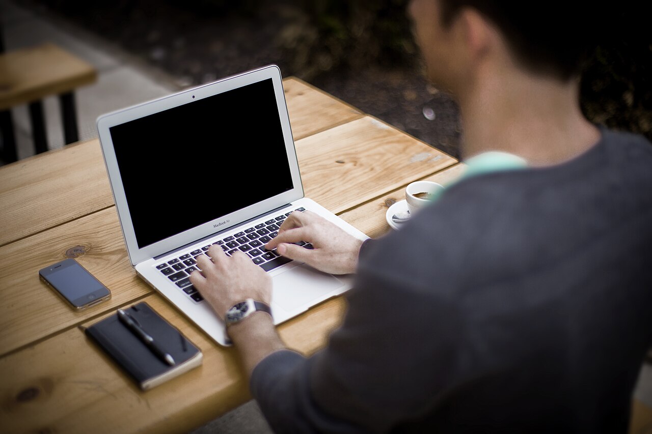 A person using a laptop outside